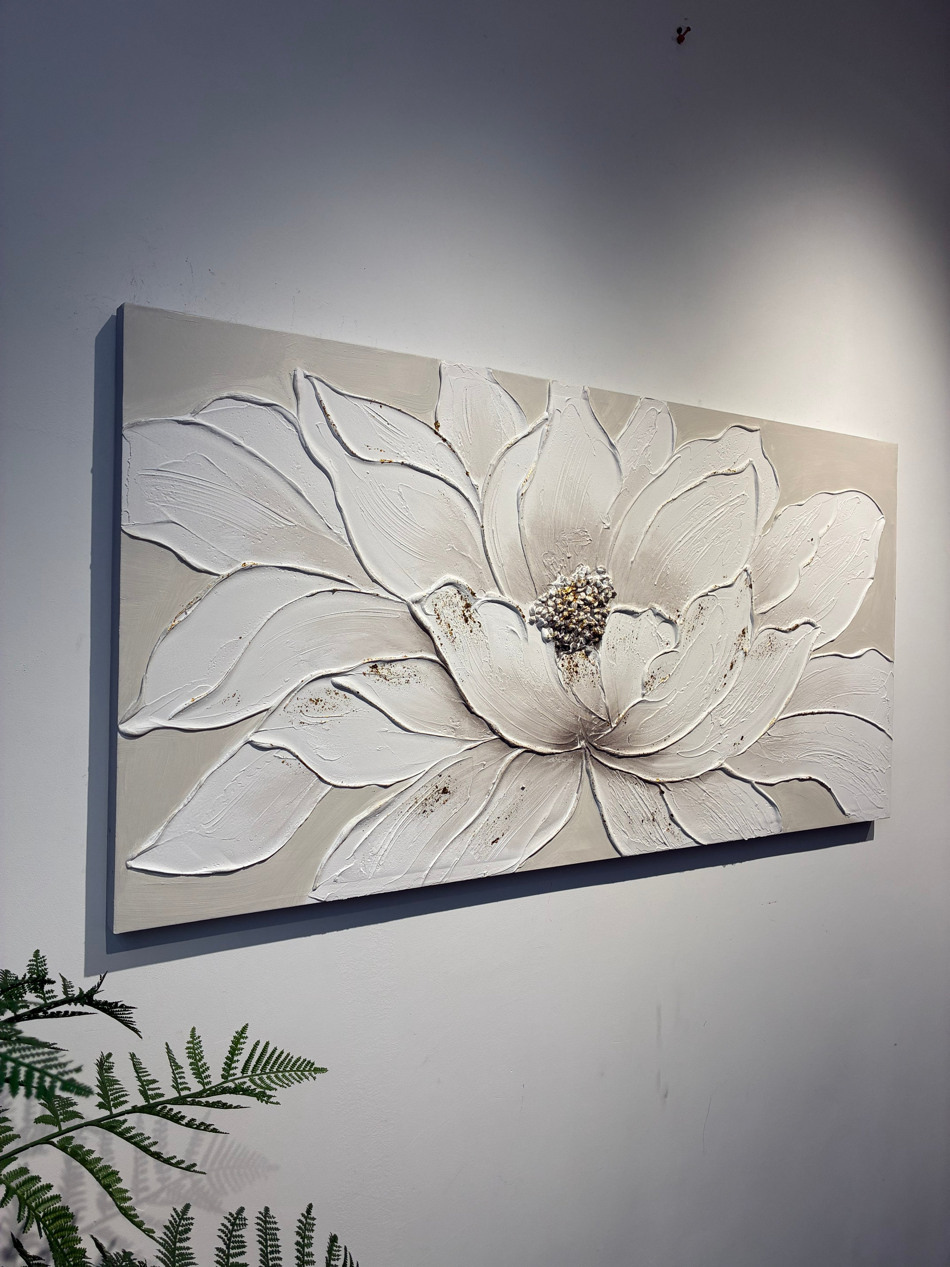 Close detail of the raised white petals and gold edging