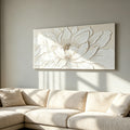 Lotus Relief canvas above a cream sectional sofa in a sunlit living room